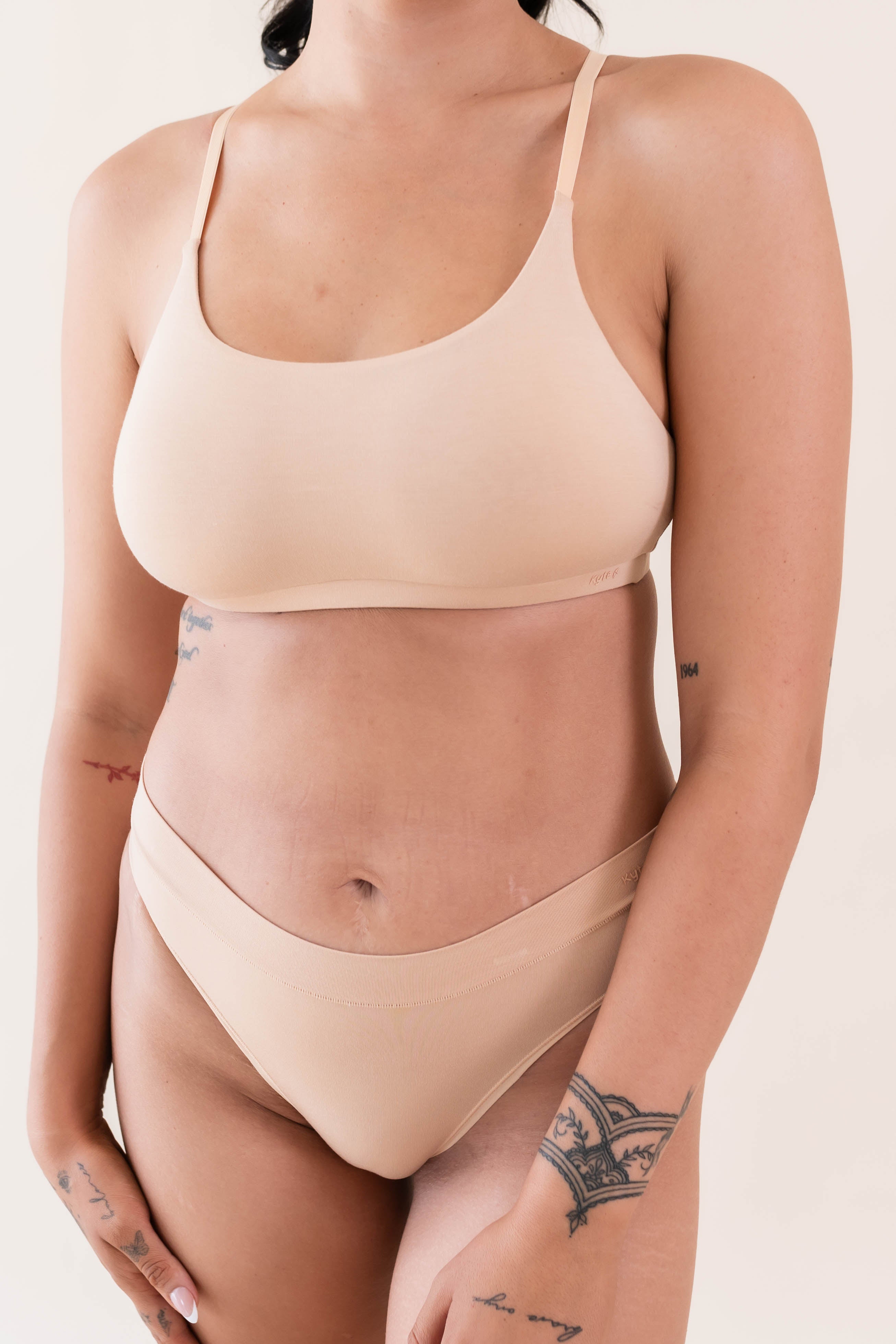 Close up of model wearing Kyte Baby's Women's Scoop Neck Bralette in Chai
