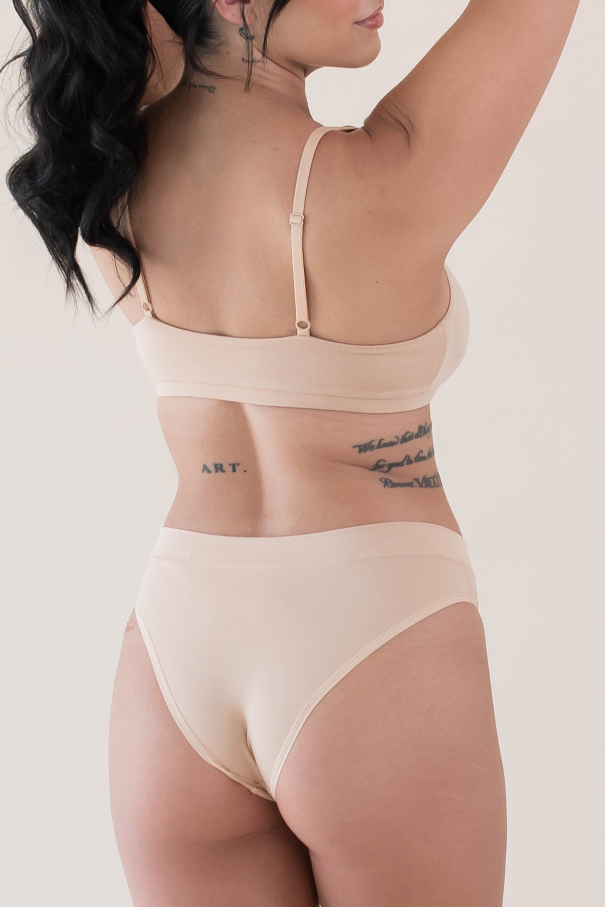 Female modeling the back of the Women's Scoop Neck Bralette in Chai