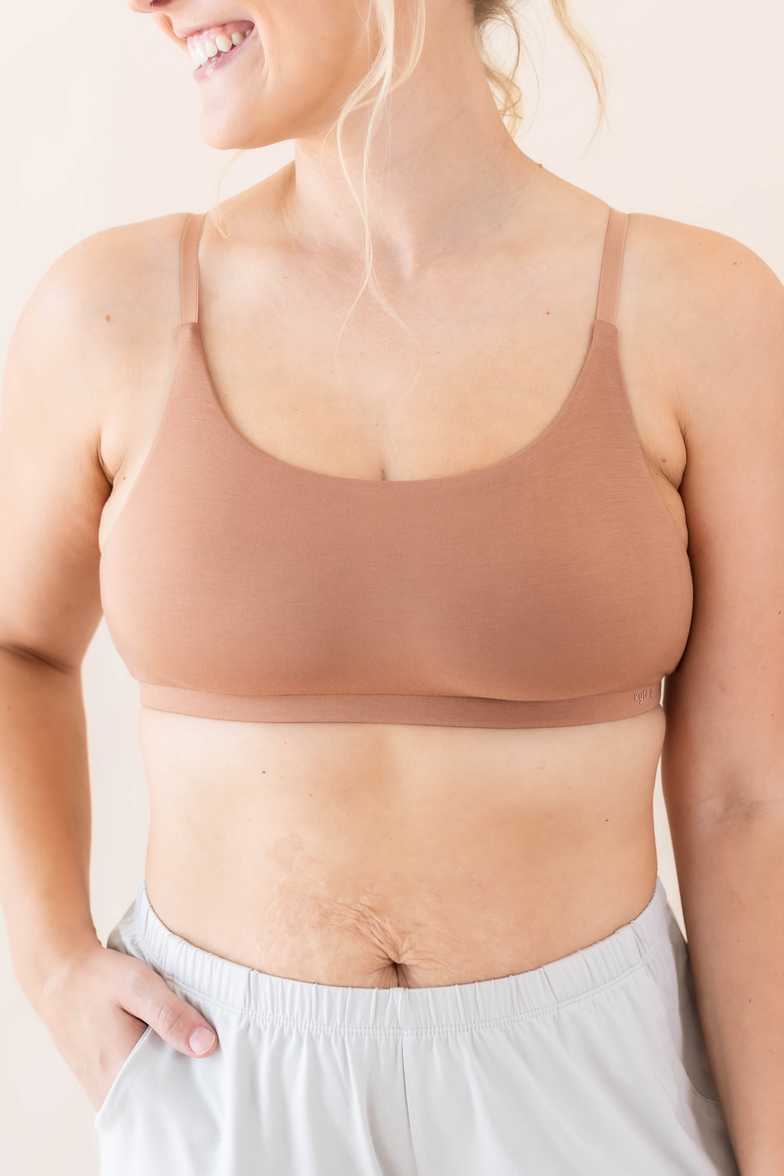Close up of model wearing the Kyte Baby's Women's Scoop Neck Bralette in Latte