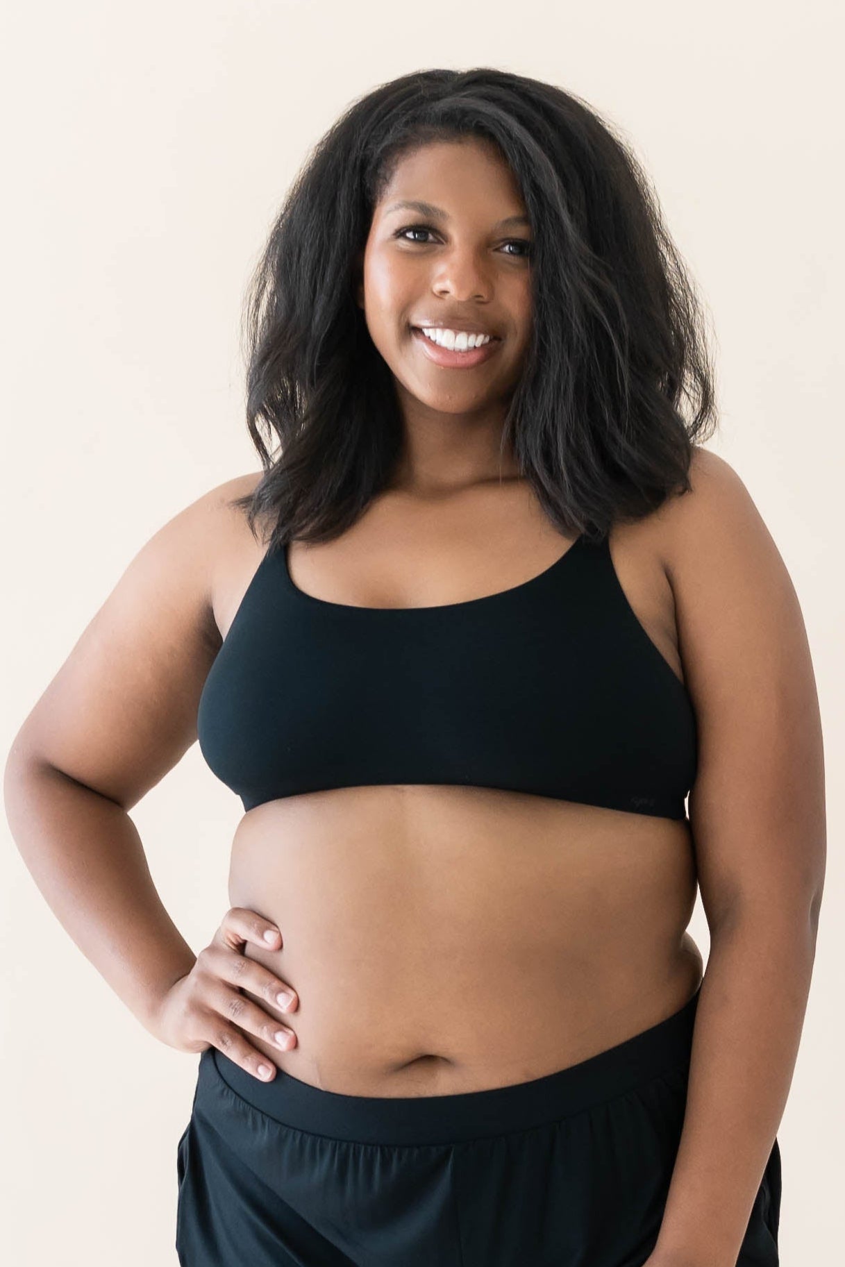 Model wearing Kyte Baby's Women's Scoop Neck Bralette in Midnight paired with Midnight Jogger bottoms