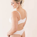 Side view of model wearing Kyte Baby's Women's Thong in Blonde