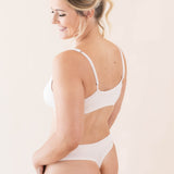 Side view of model wearing Kyte Baby's Women's Thong in Blonde