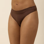 Brown thong underwear on a beige background