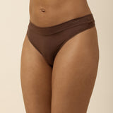 Brown thong underwear on a beige background