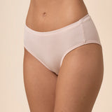 Light pink mid-waisted underwear on a beige background