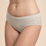 Beige underwear worn by a person on a beige background