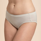 Beige underwear worn by a person on a beige background