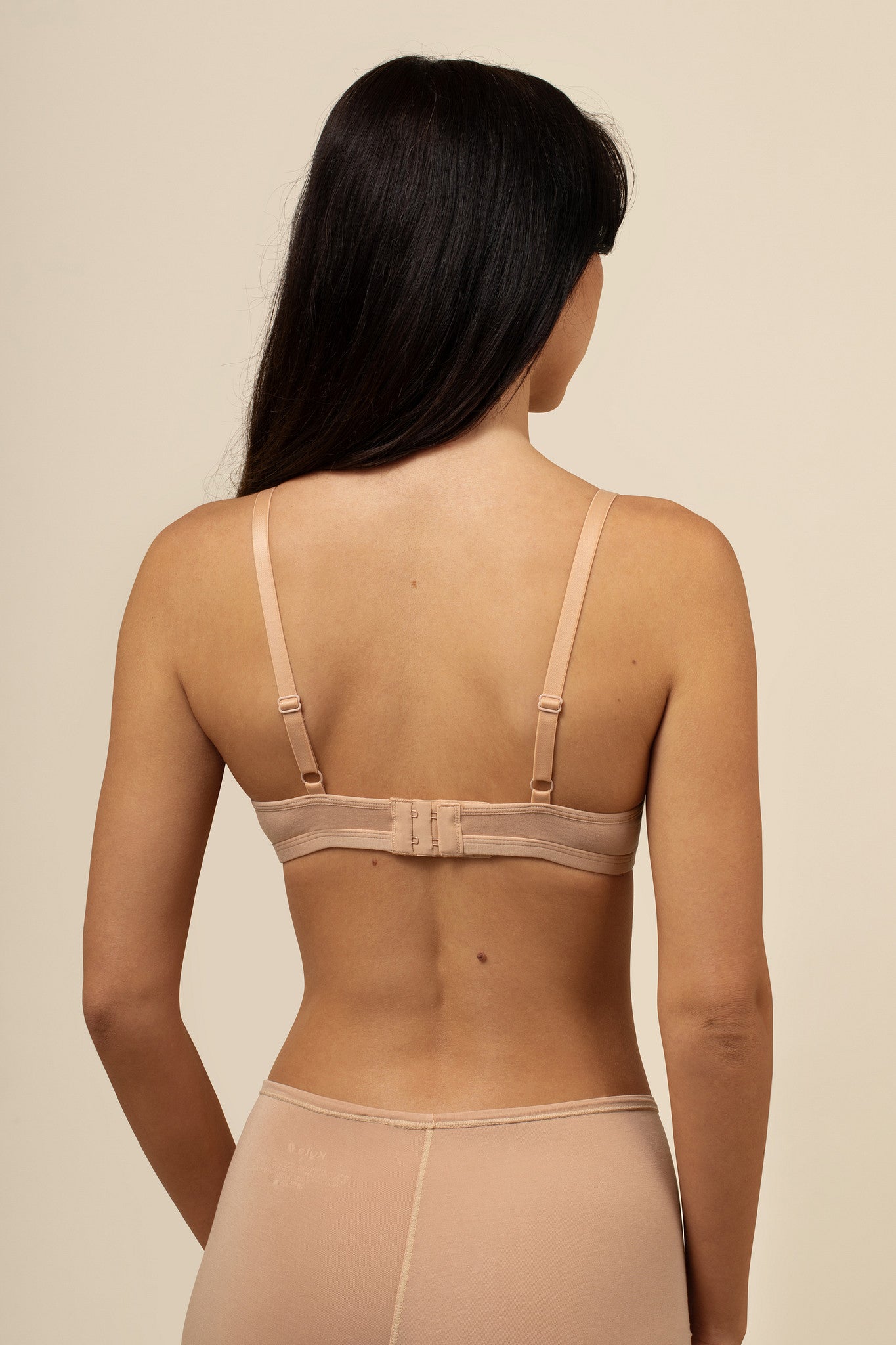 Back side of the  Women's V-Neck Bra in Chai  on a model 