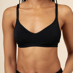 Woman modeling the Women's V Neck Bra in Midnight paired with matching briefs ::: Model is 32C wearing size S ///