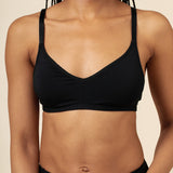 Woman modeling the Women's V Neck Bra in Midnight paired with matching briefs ::: Model is 32C wearing size S ///