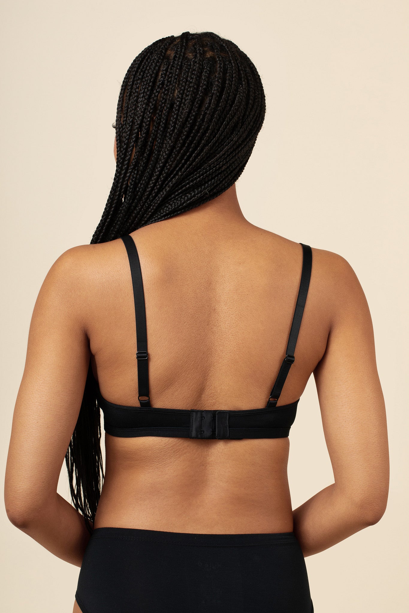 Model showcasing the back and straps of the Women's V-Neck Bra in Midnight