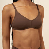 Close up of model wearing the Women's V Neck Bra in Toffee paired with matching briefs ::: Model is 32C wearing size S ///