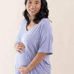 Expectant mother cradling her baby bump wearing the Women’s Relaxed Fit V-Neck in Taro