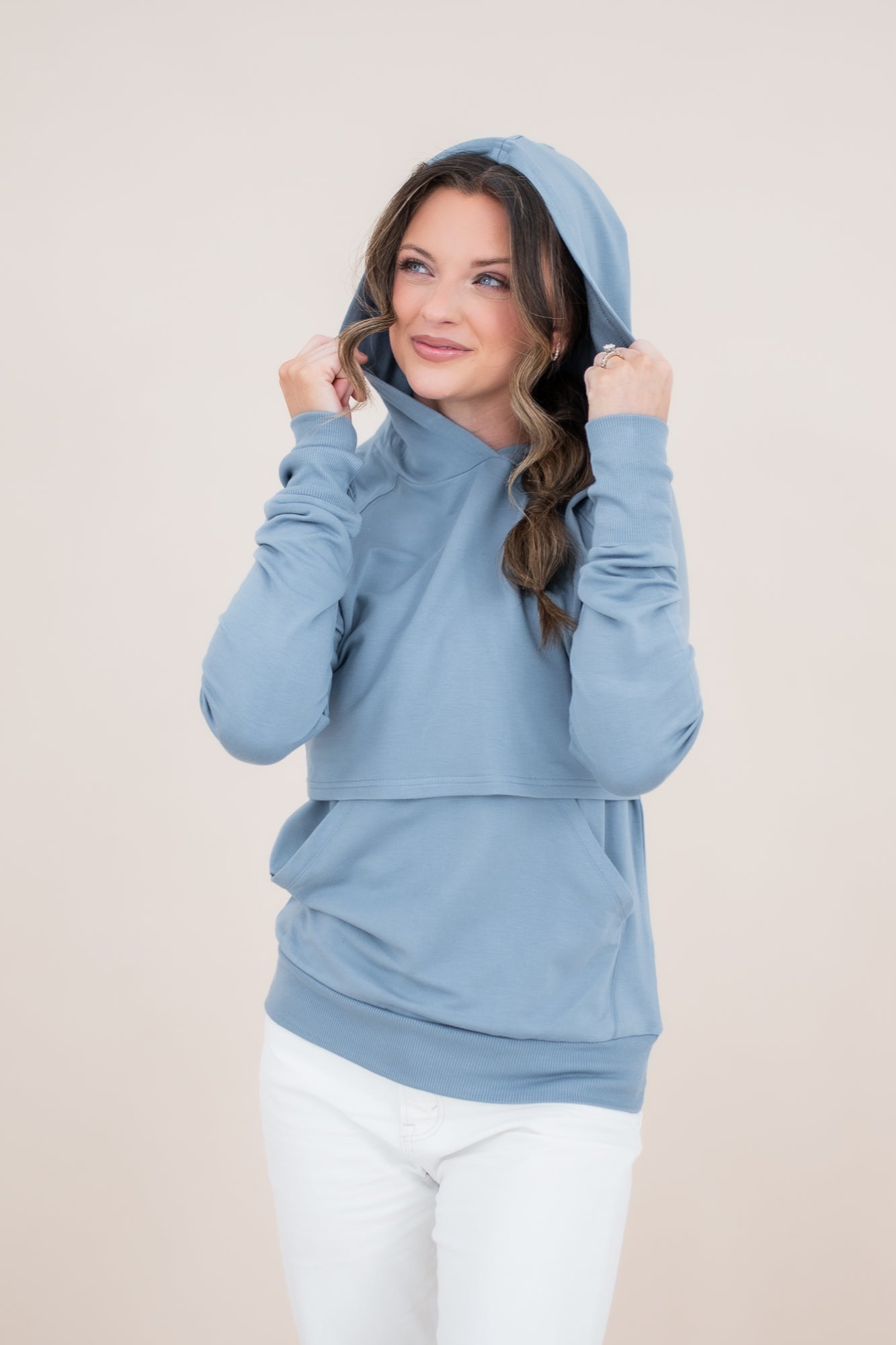 Model looking to the side with a hoodie while modeling the Kyte Women's French Terry Nursing Hoodie in Slate