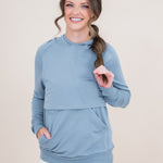 Woman modeling the Kyte Women's French Terry Nursing Hoodie in Slate with her hand in the pocket