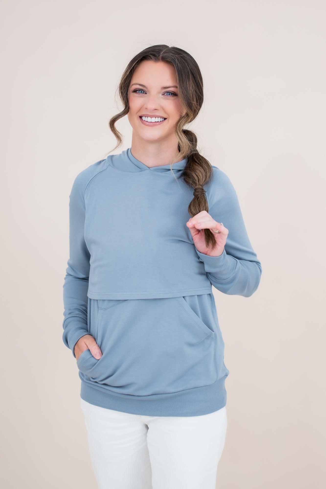 Woman modeling the Kyte Women's French Terry Nursing Hoodie in Slate with her hand in the pocket
