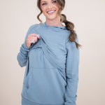 Female modeling the Women's French Terry Nursing Hoodie in Slate lifting the front fabric of the hoodie