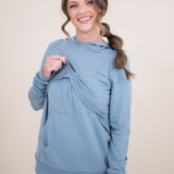 Female modeling the Women's French Terry Nursing Hoodie in Slate lifting the front fabric of the hoodie
