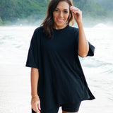 Female model standing in the sand wearing the Women’s Biker Short Set in Midnight