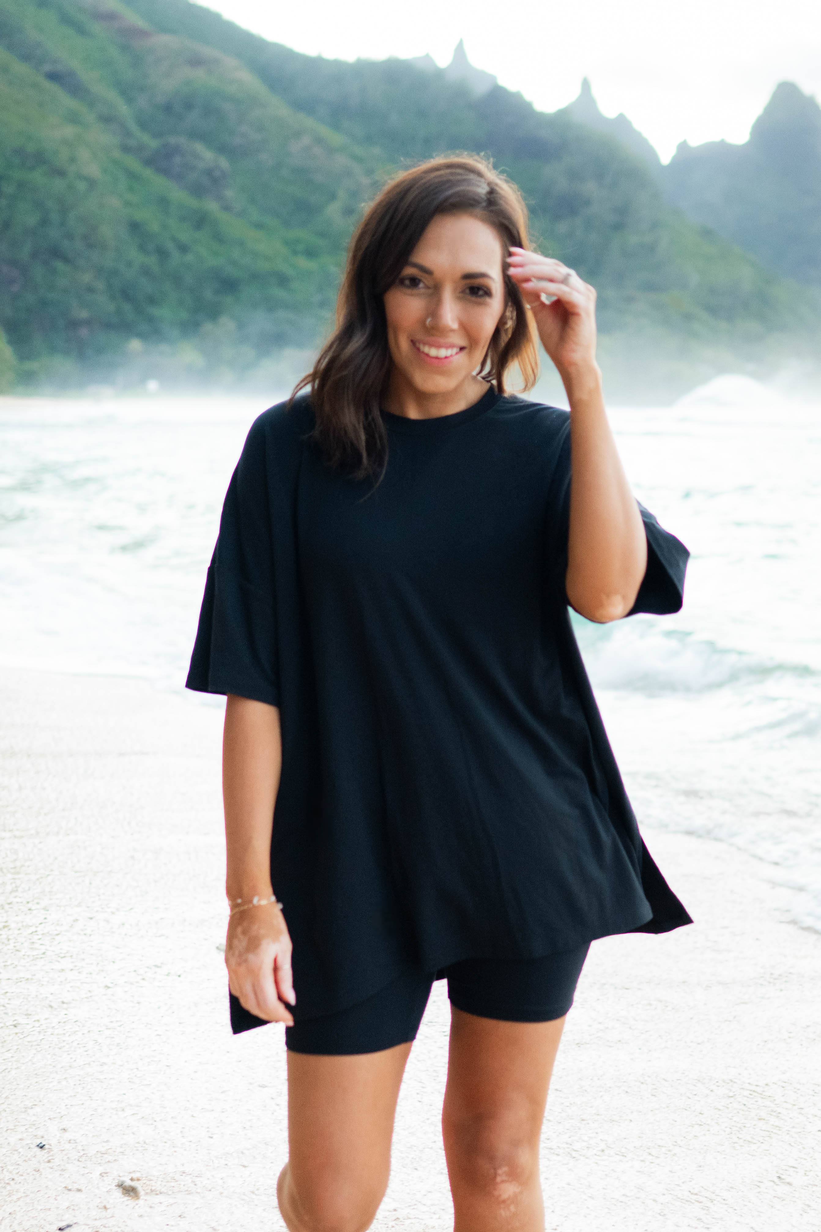 Female model standing in the sand wearing the Women’s Biker Short Set in Midnight