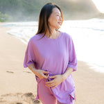 Female model in the sand on the beach wearing the Women’s Biker Short Set in Poi