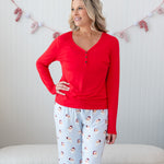 Model with arm on her hip while wearing the Women's Long Sleeve Henley Tee in Cardinal