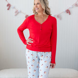 Model with arm on her hip while wearing the Women's Long Sleeve Henley Tee in Cardinal