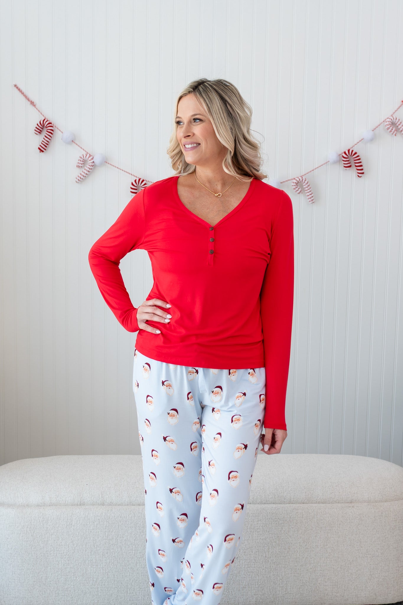 Model with arm on her hip while wearing the Women's Long Sleeve Henley Tee in Cardinal