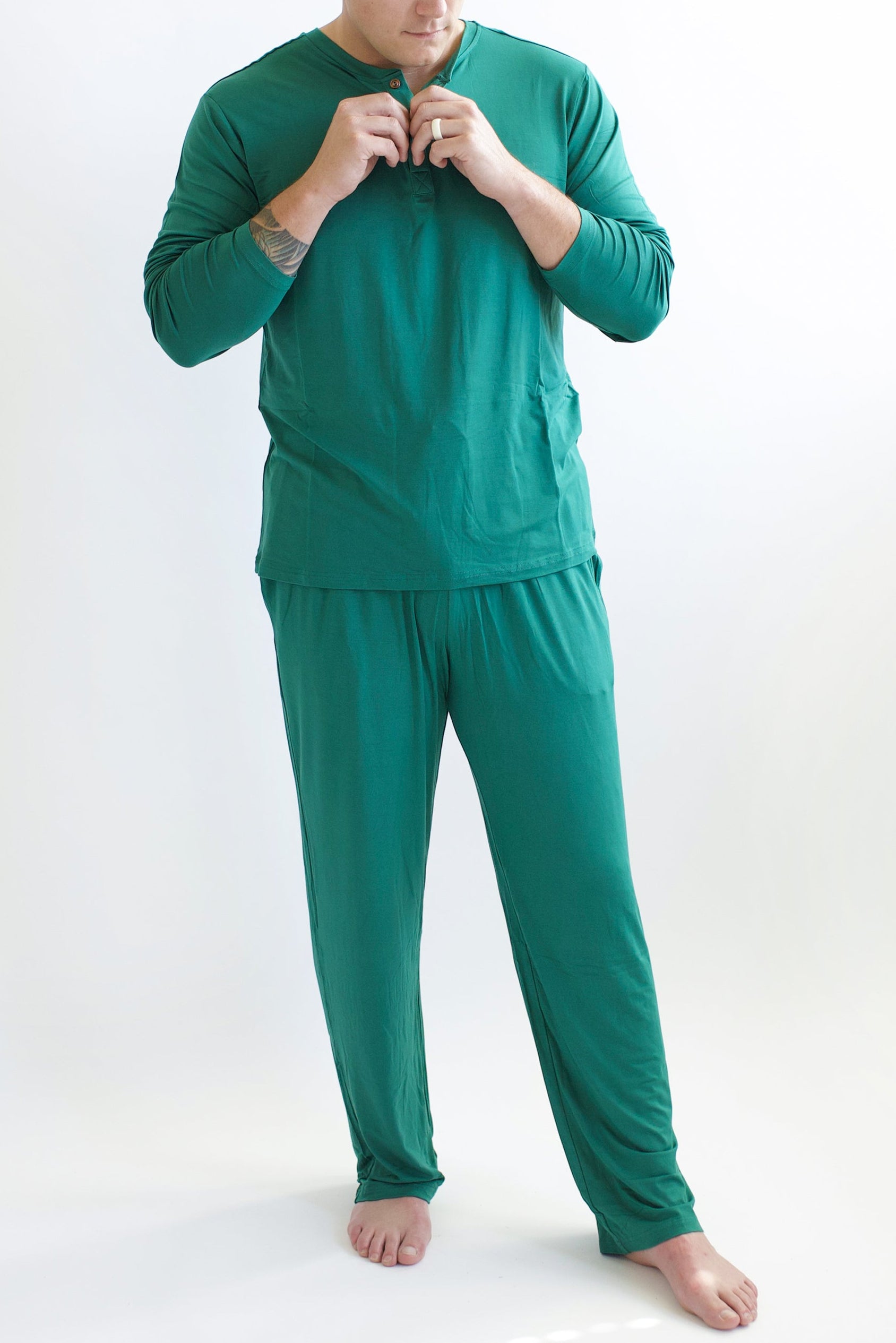 Model wearing the Men's Lounge Pants in Emerald paired with matching Henley top