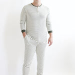 Male model wearing the Men's Ribbed Henley Set in Fir Stripe standing in front of a white backdrop