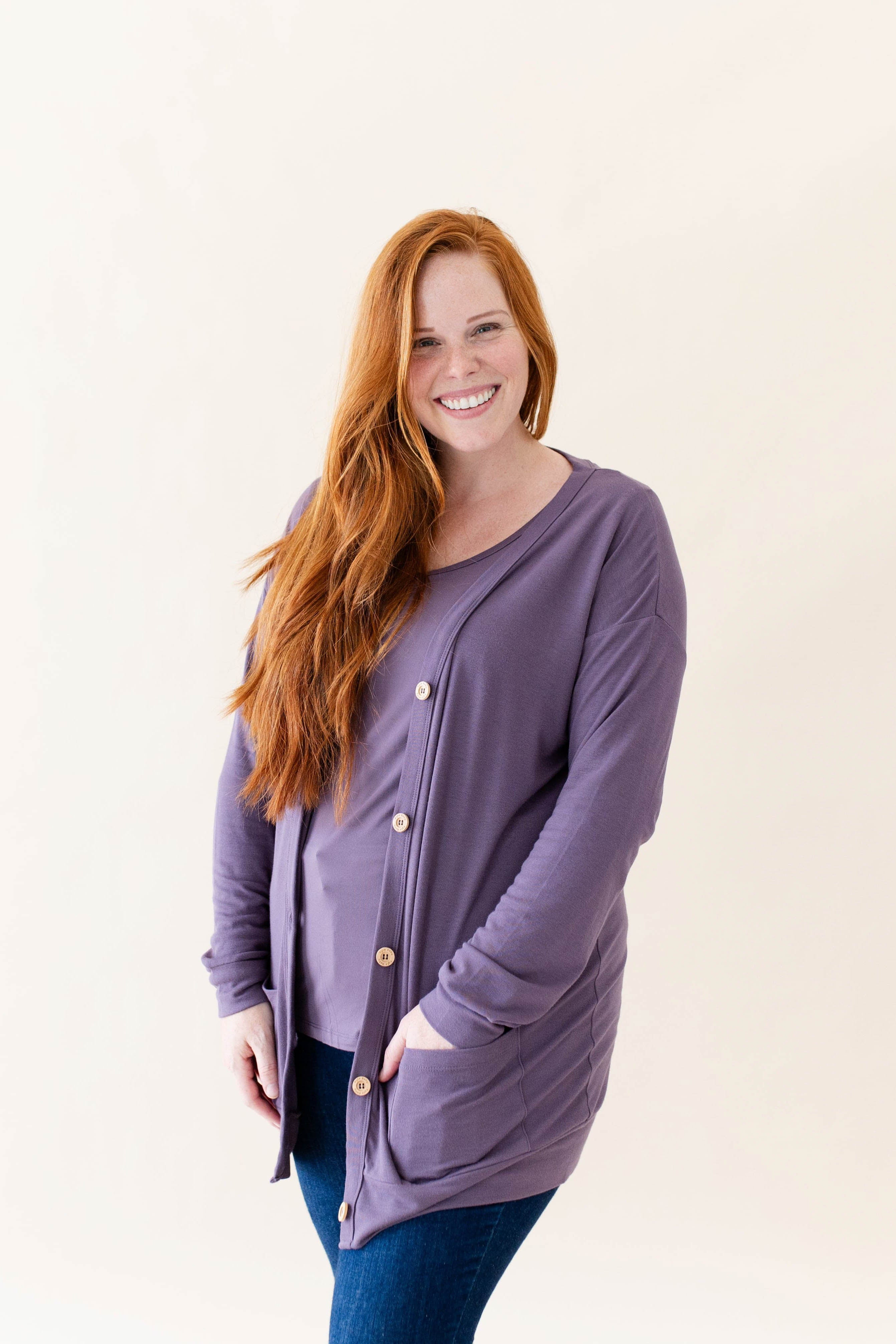 Female modeling the Bamboo Jersey Adult Cardigan in Currant paired with a Currant shirt and dark wash jeans