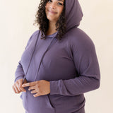 Model wearing the Women's Ribbed Hoodie in Currant paired with Currant Jogger Pants
