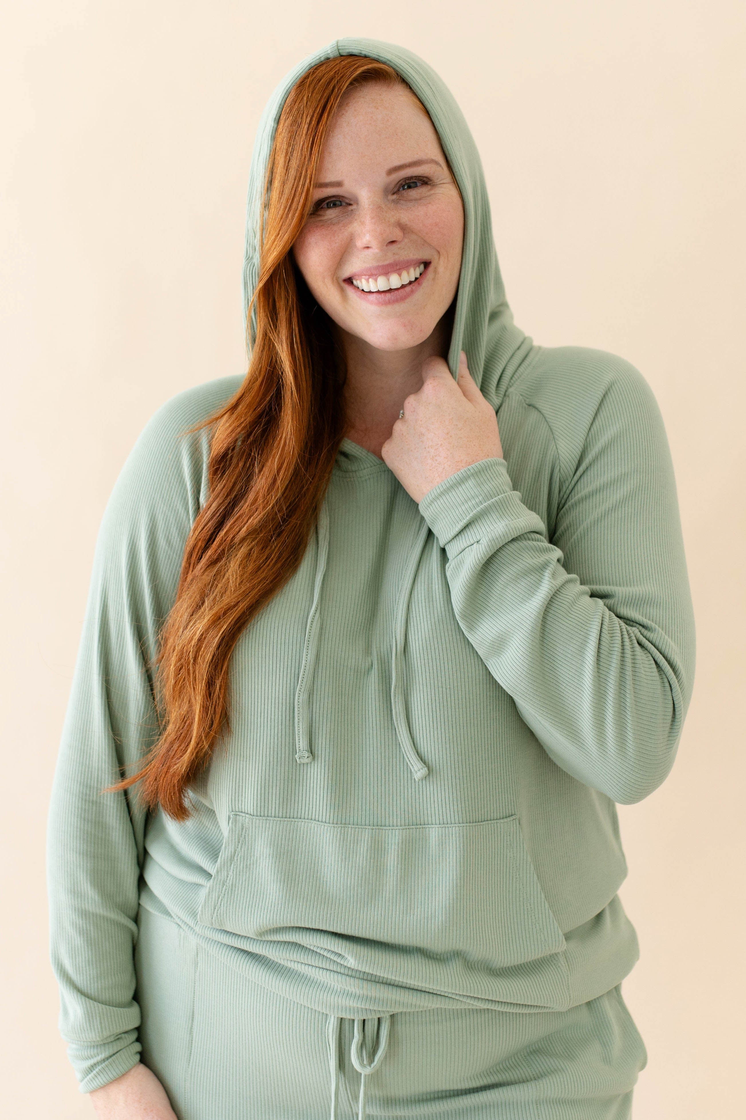 Model wearing the Women's Ribbed Hoodie in Thyme paired with Thyme Jogger Pants