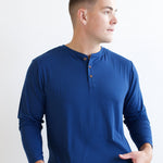 Male model looking to the side while wearing the Men's Long Sleeve Henley Top in Tahoe