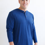 Smiling man modeling the Kyte Men's Long Sleeve Henley Top in Tahoe