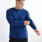 Model fixing sleeve on the Kyte Men's Long Sleeve Henley Top in Tahoe