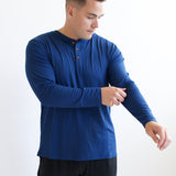 Model fixing sleeve on the Kyte Men's Long Sleeve Henley Top in Tahoe