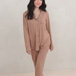 Woman modeling long sleeve light brown pajama set in a neutral room