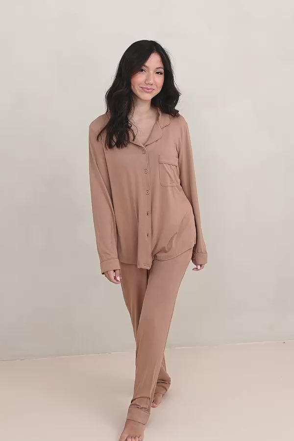 Woman modeling long sleeve light brown pajama set in a neutral room