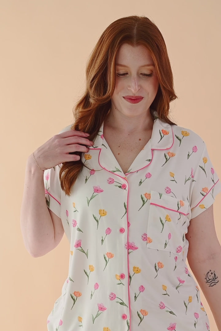 Video of model wearing short sleeve pajama set with tulip pattern  