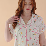 Video of model wearing short sleeve pajama set with tulip pattern  ::: Model is 5'7" wearing size M ///