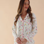 Video of woman modeling long sleeve button up pajamas in a tulip pattern ::: Model is 5'11" wearing size S ///