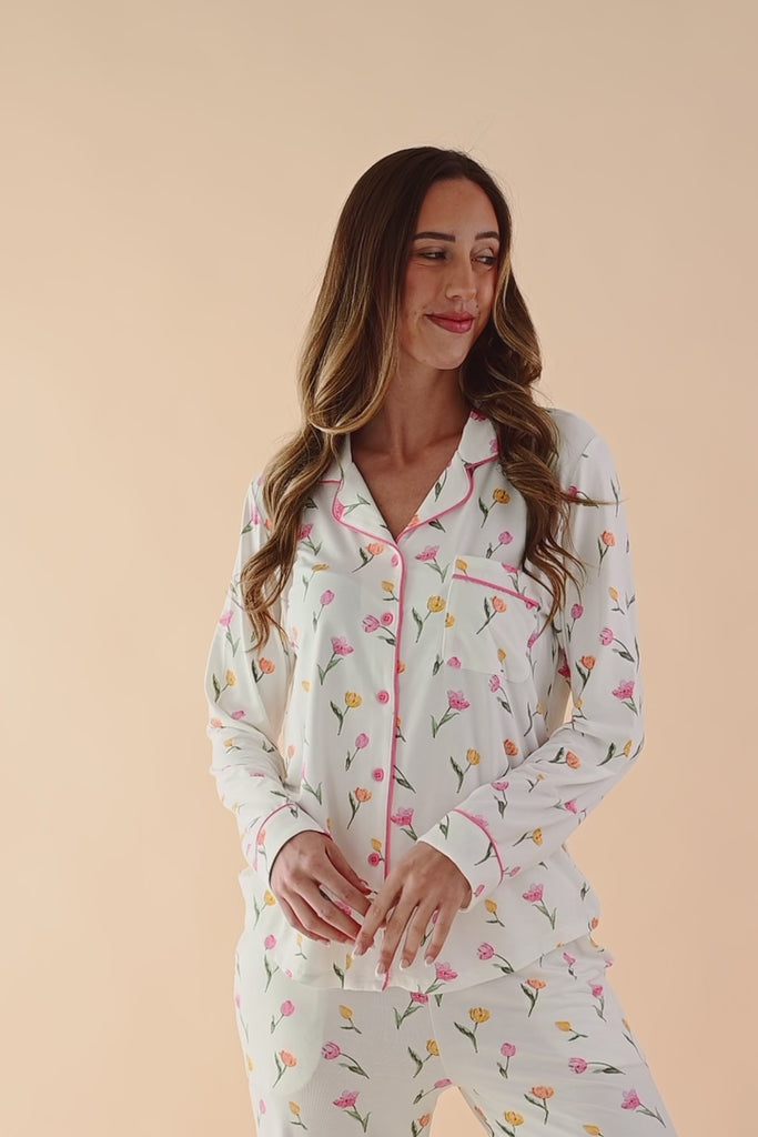 Video of woman modeling long sleeve button up pajamas in a tulip pattern ::: Model is 5'11" wearing size S ///