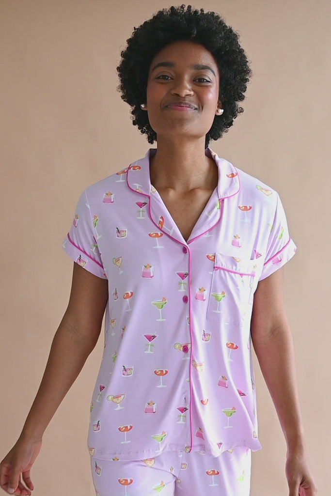 Video of model wearing short sleeve with cropped pant pajama set with cocktail print ::: Model is 5'9" wearing size S ///