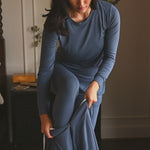 Woman modeling a dark blue sleep sack