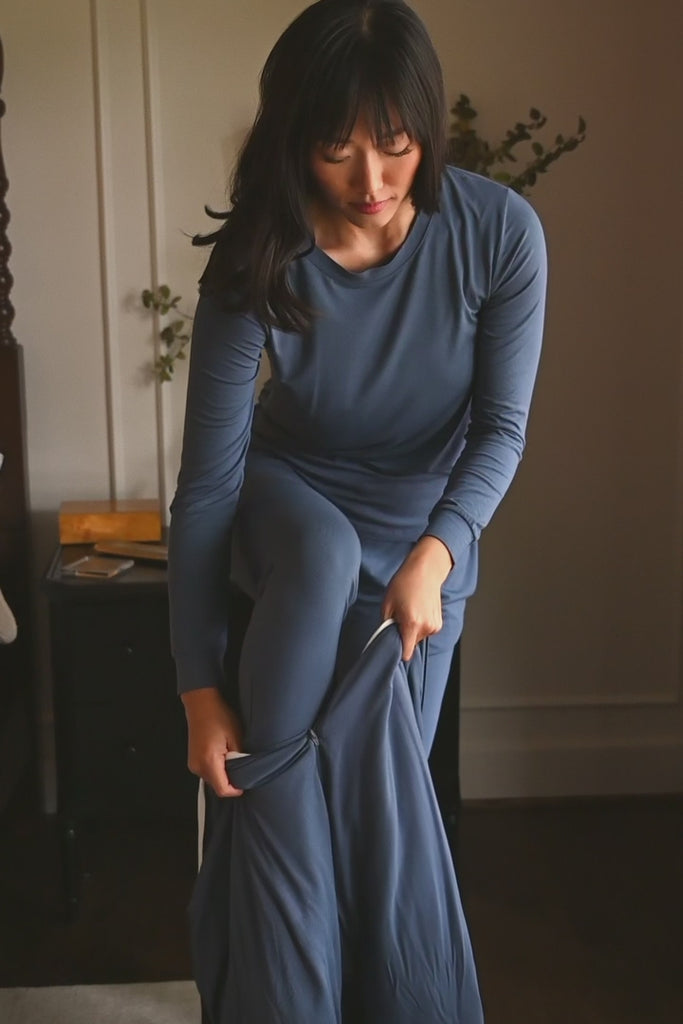 Woman modeling a dark blue sleep sack