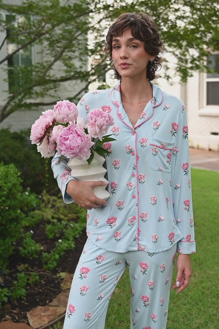 Video of woman outside wearing long sleeve  pajamas and pants in Peony on Breeze print. 