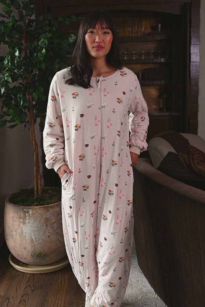 Woman wearing a cream colored long sleeve sleep sack with a book pattern