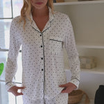 Woman modeling Long-Sleeved Women's Pajama Set in Midnight Polka Dot in an elevated home