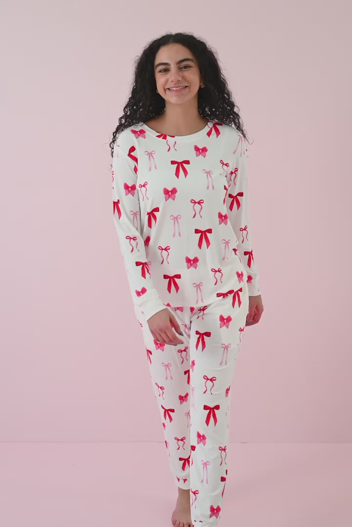 Woman modeling matching jogger set with red bow print